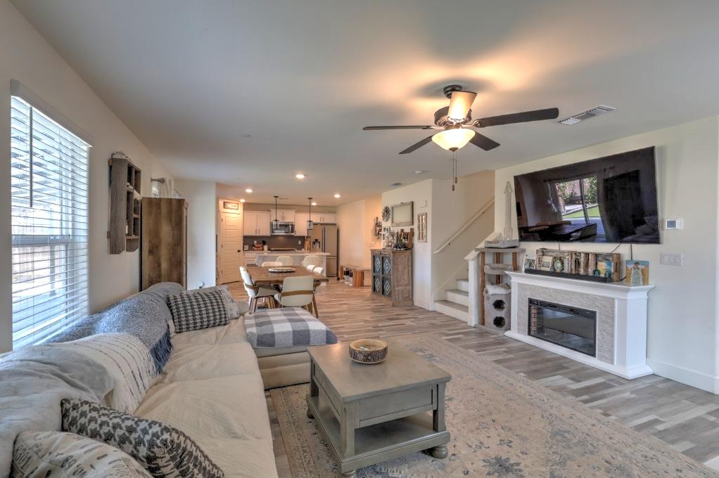 2129 Redding Way Atwater, CA 95301 - Photo 14 of 75 a living room with furniture a fireplace and a flat screen tv