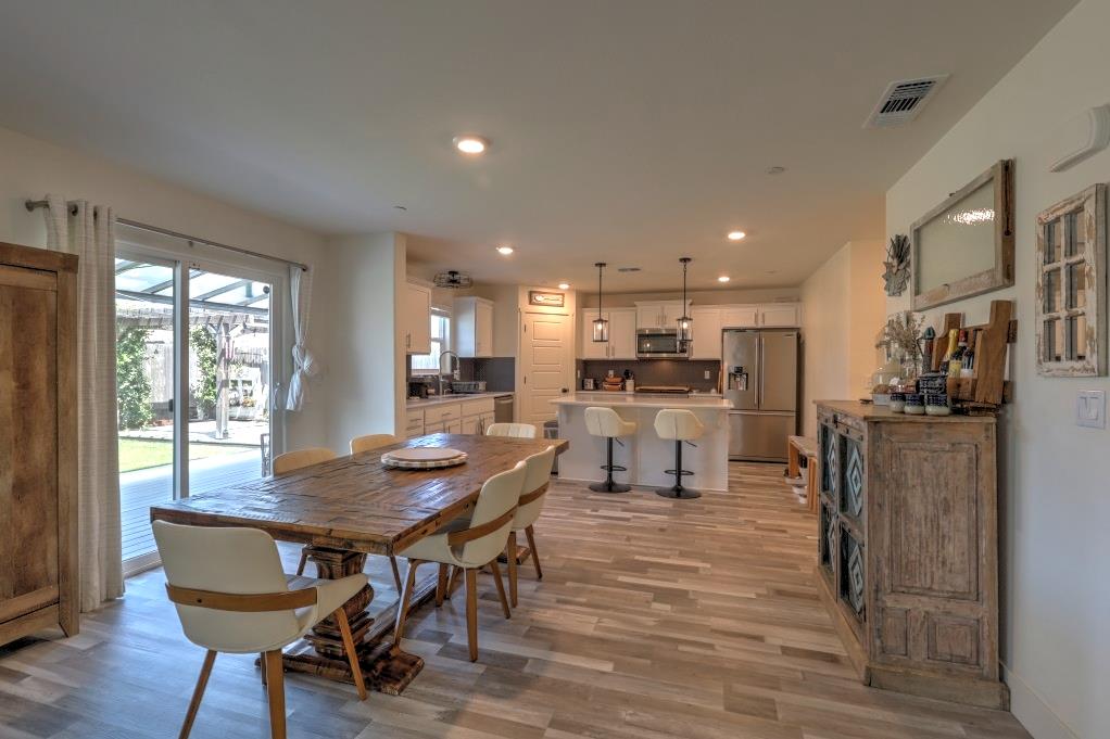 2129 Redding Way Atwater, CA 95301 - Photo 19 of 75 a view of a dining room with furniture and wooden floor