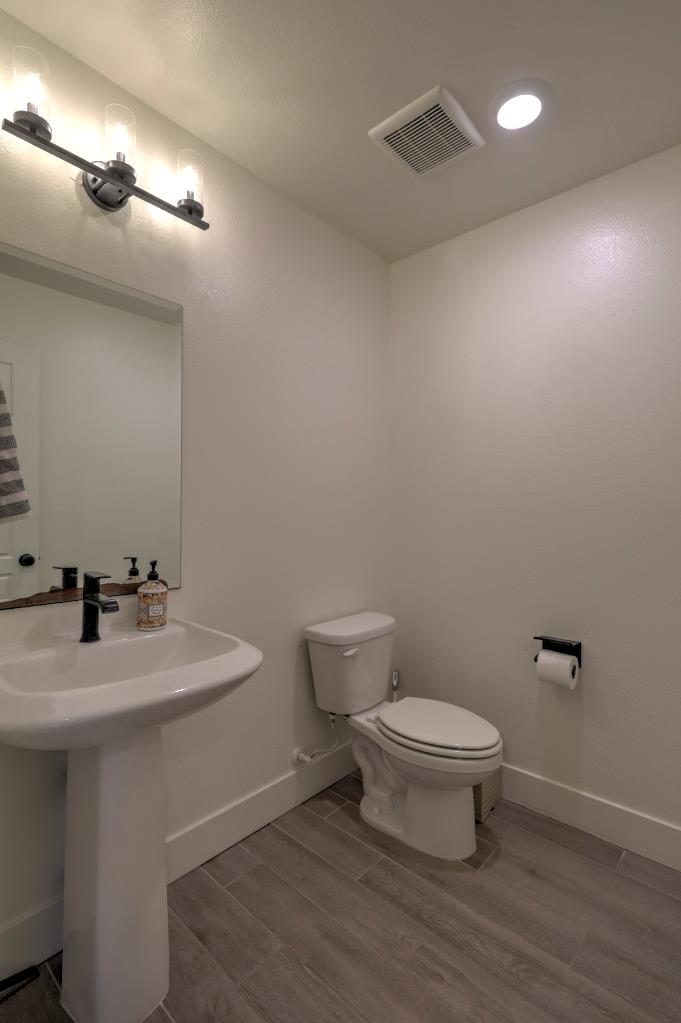 2129 Redding Way Atwater, CA 95301 - Photo 22 of 75 a bathroom with a toilet sink and mirror