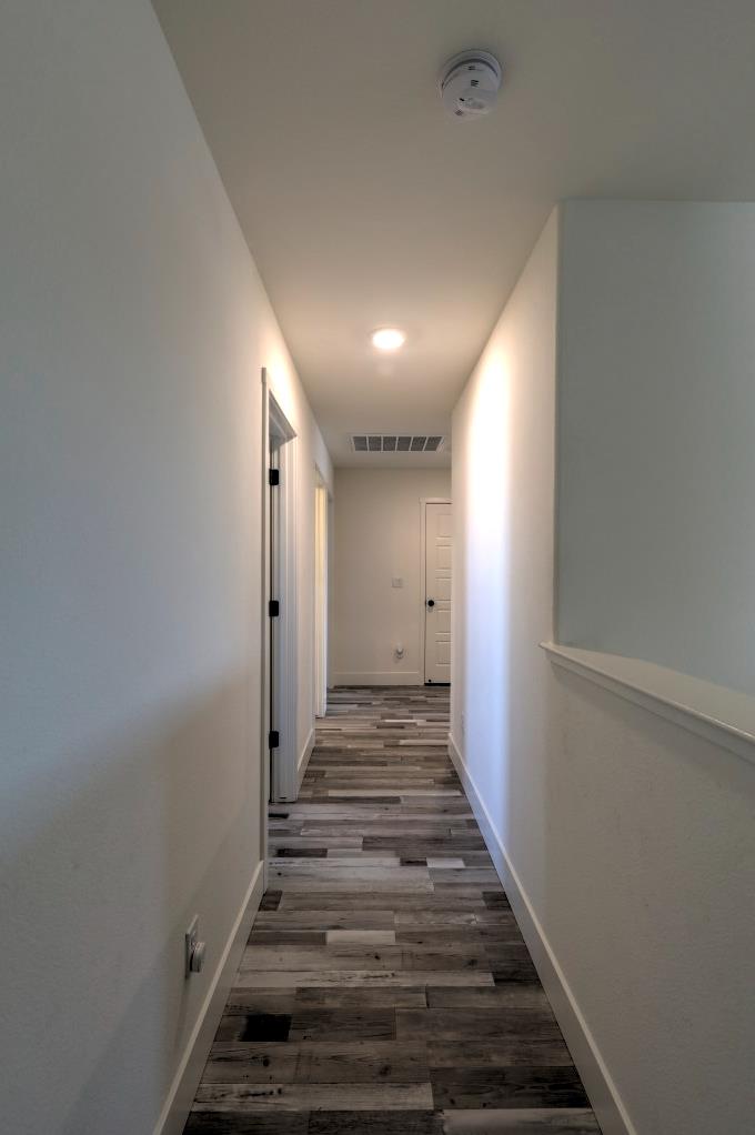 2129 Redding Way Atwater, CA 95301 - Photo 27 of 75 a view of a hallway with wooden floor and staircase