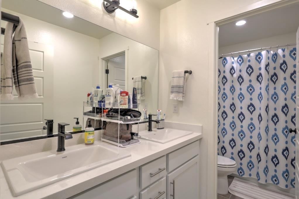 2129 Redding Way Atwater, CA 95301 - Photo 36 of 75 a bathroom with a sink toilet and shower