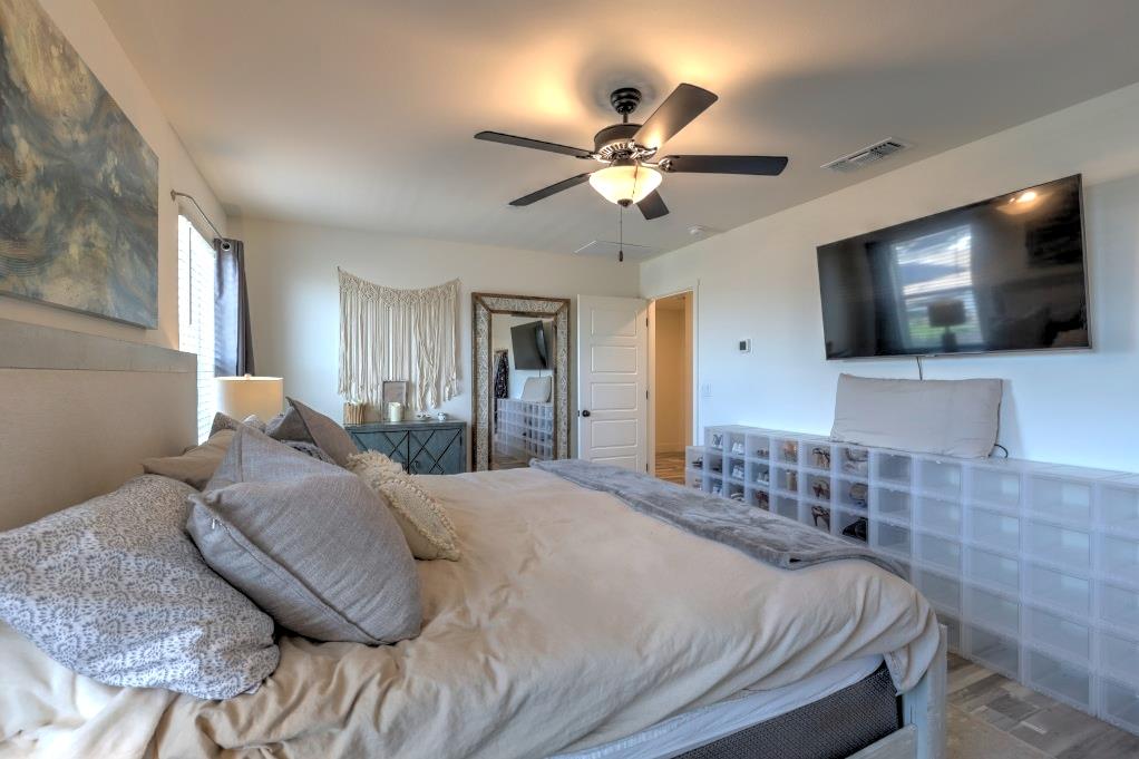 2129 Redding Way Atwater, CA 95301 - Photo 40 of 75 a bedroom with a large bed and a flat screen tv