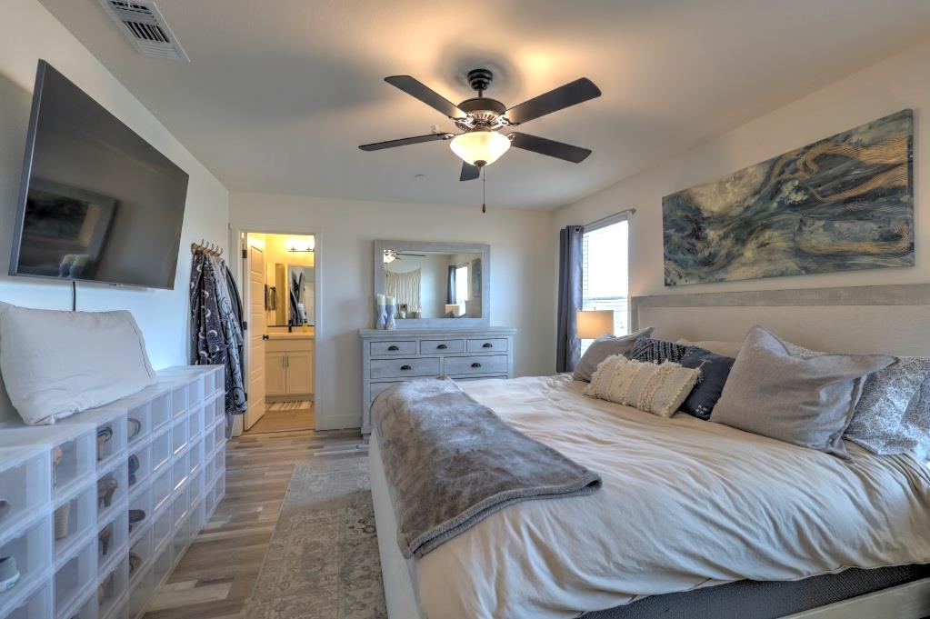 2129 Redding Way Atwater, CA 95301 - Photo 41 of 75 a bedroom with a large bed a flat tv screen and a dresser