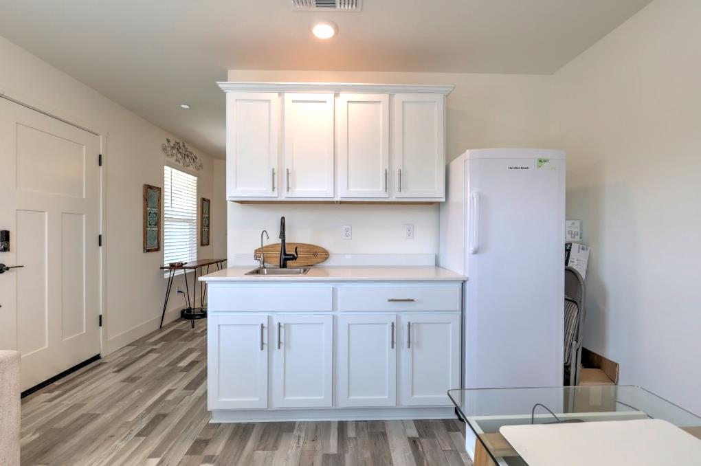 2129 Redding Way Atwater, CA 95301 - Photo 64 of 75 a kitchen with stainless steel appliances white cabinets and wooden floor