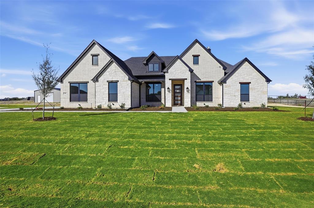 a front view of house with yard and green space