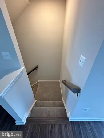 a view of staircase with wooden floor