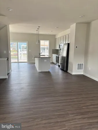 a view of a living room with hardwood floor and a window