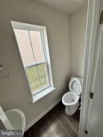 a bathroom with a toilet and a window