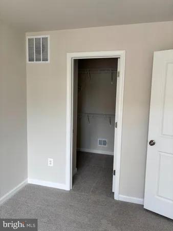 a view of an empty room with a bathroom
