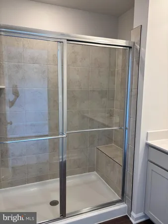 a bathroom with a glass shower door