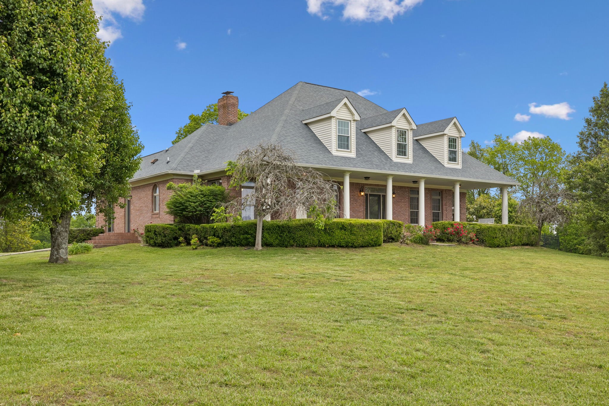 a front view of a house with a garden