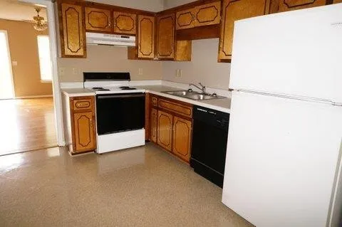 a kitchen with stainless steel appliances a stove a sink and a refrigerator
