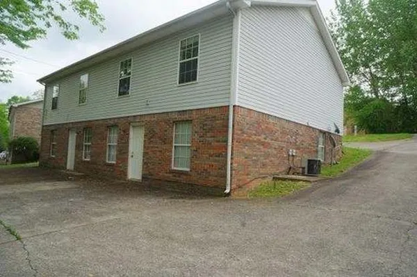 a view of a house with a yard and garage