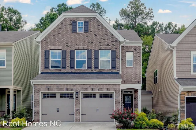 a front view of a house with plants