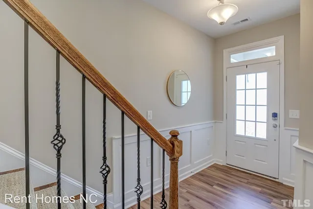 a view of an entryway with wooden floor and stairs