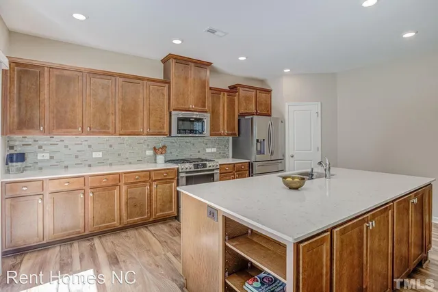 a kitchen with a stove a sink and a refrigerator