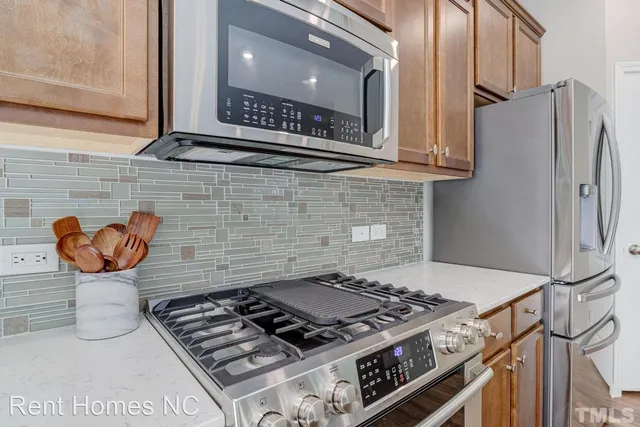 a stove top oven sitting inside of a kitchen