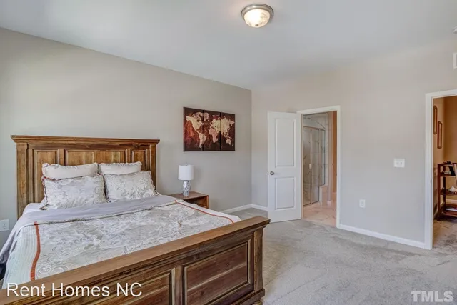 a bedroom with a bed and a painting on the wall