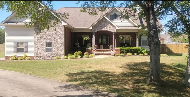 a view of a house with backyard and sitting area