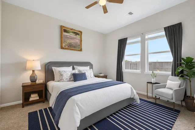 a bedroom with a bed and a large window