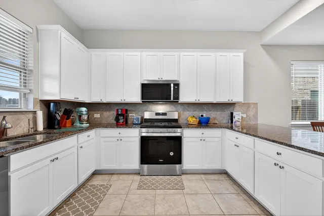 a kitchen with stainless steel appliances granite countertop a sink and cabinets