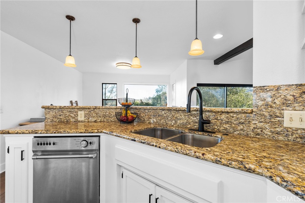 8110 Castenada Lane Atascadero, CA 93422 - Photo 20 of 75 a kitchen with kitchen island granite countertop a sink a counter top space and cabinets
