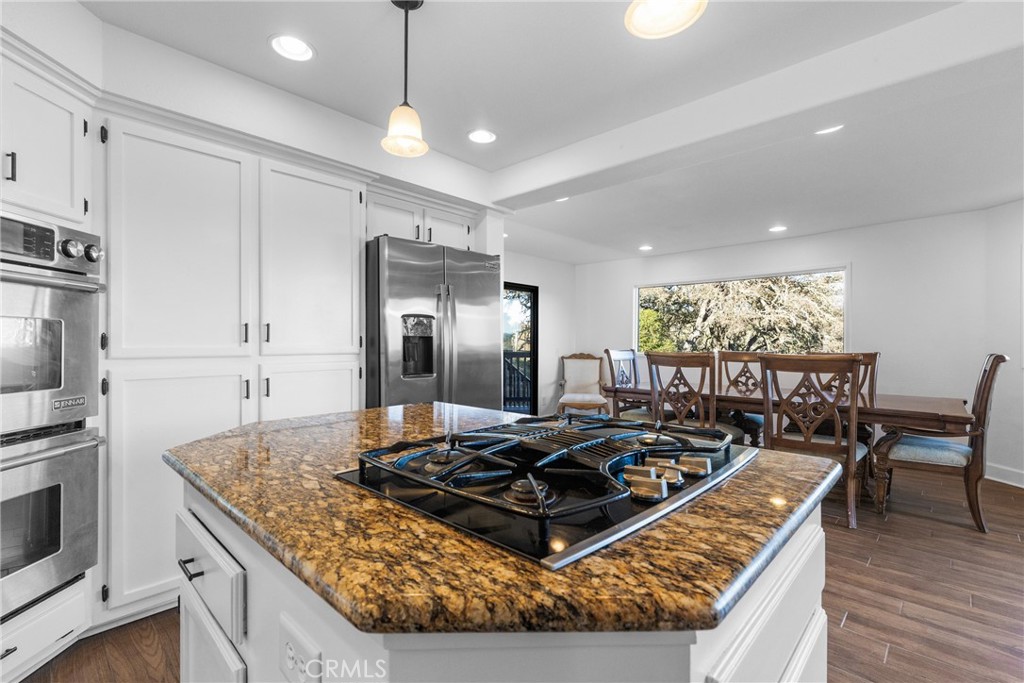 8110 Castenada Lane Atascadero, CA 93422 - Photo 21 of 75 a kitchen with stainless steel appliances granite countertop a stove a refrigerator and a kitchen island