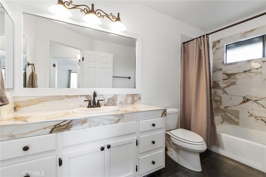 8110 Castenada Lane Atascadero, CA 93422 - Photo 34 of 75 a bathroom with a sink a toilet and a bathtub