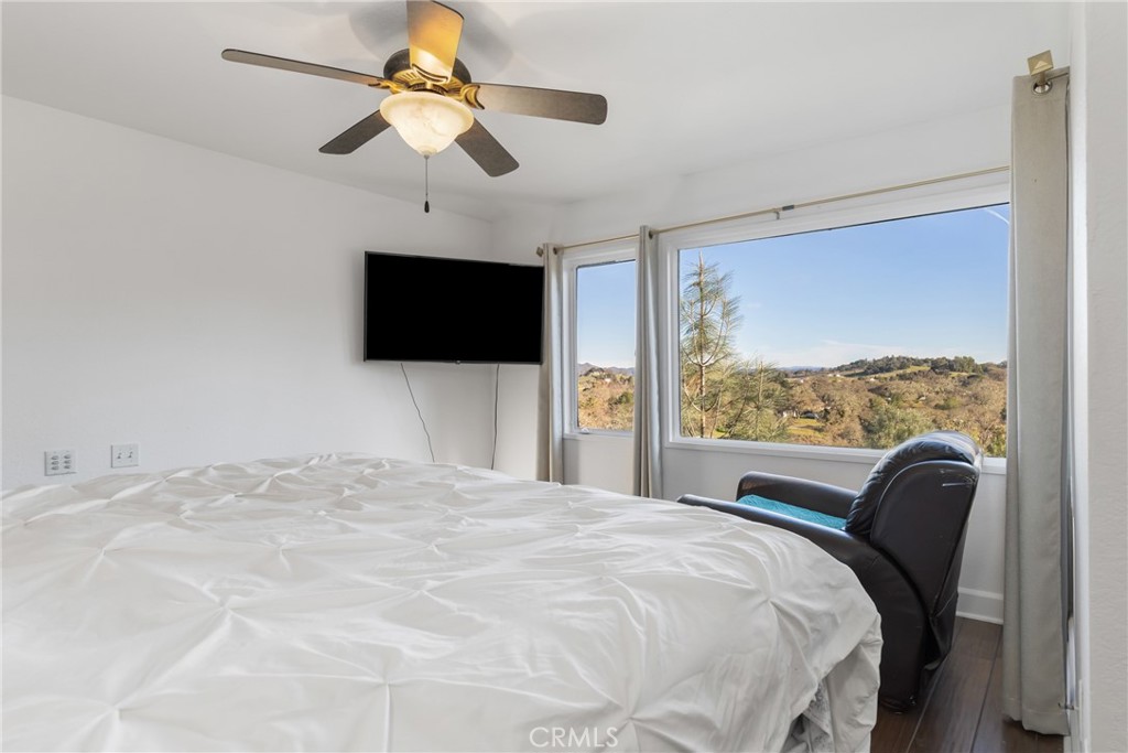 8110 Castenada Lane Atascadero, CA 93422 - Photo 38 of 75 a bedroom with a bed tv and a window