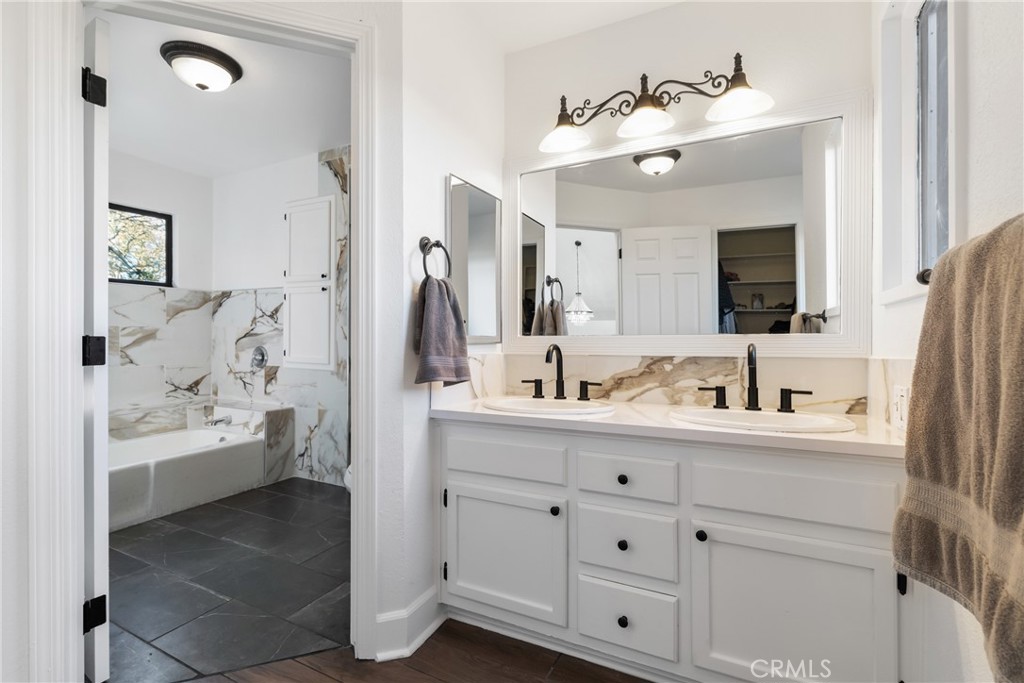 8110 Castenada Lane Atascadero, CA 93422 - Photo 43 of 75 a bathroom with a double vanity sink and mirror