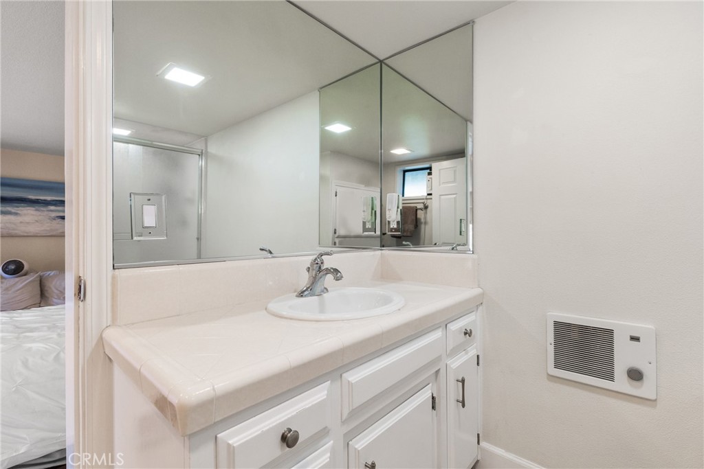 8110 Castenada Lane Atascadero, CA 93422 - Photo 52 of 75 a bathroom with a sink vanity and a mirror