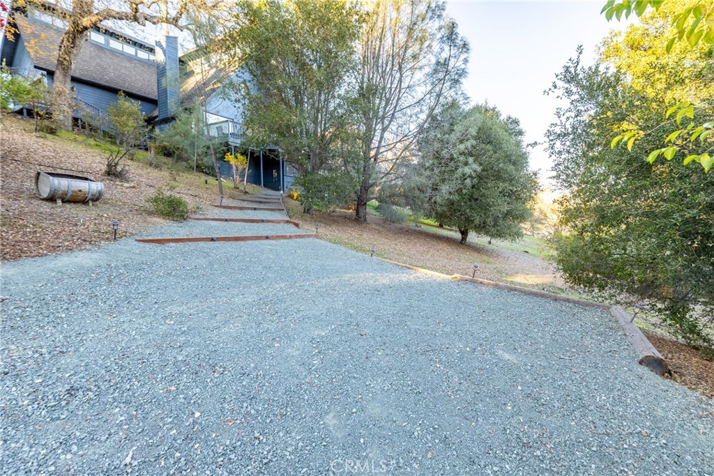 8110 Castenada Lane Atascadero, CA 93422 - Photo 56 of 75 Part way up the driveway is a separate parking area or an area for guests to park for the guest suite. Pathway leads up to the private entrance of the guest suite.