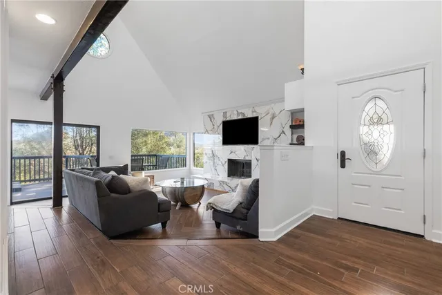 a living room with furniture a flat screen tv and a fireplace