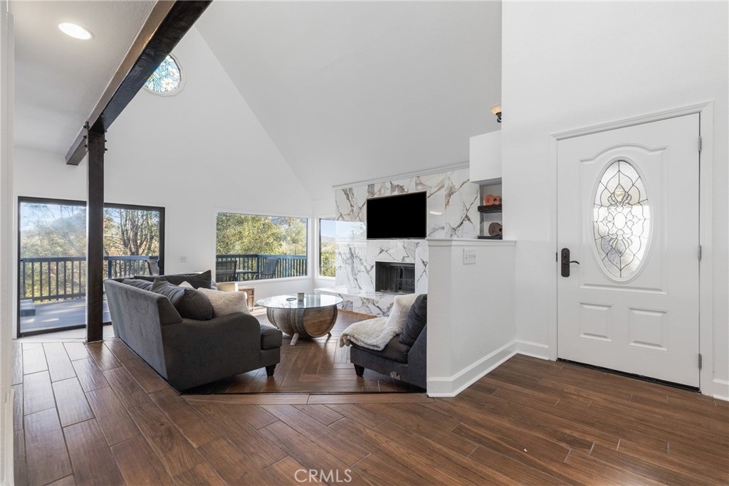 8110 Castenada Lane Atascadero, CA 93422 - Photo 8 of 75 a living room with furniture a flat screen tv and floor to ceiling window