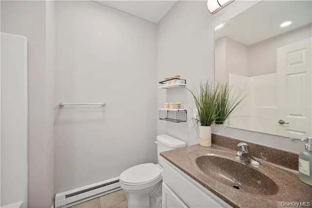 a bedroom with a large bed and a potted plant