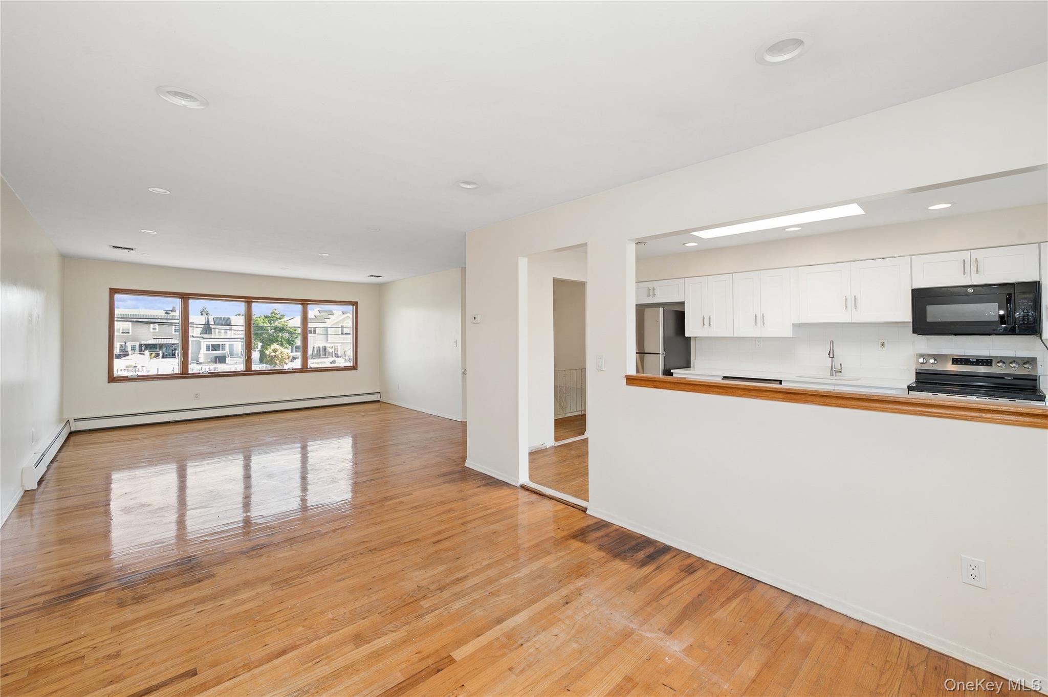 2625 Riverside Drive Wantagh, NY 11793 - Photo 11 of 20 a view of an empty room with wooden floor and a window