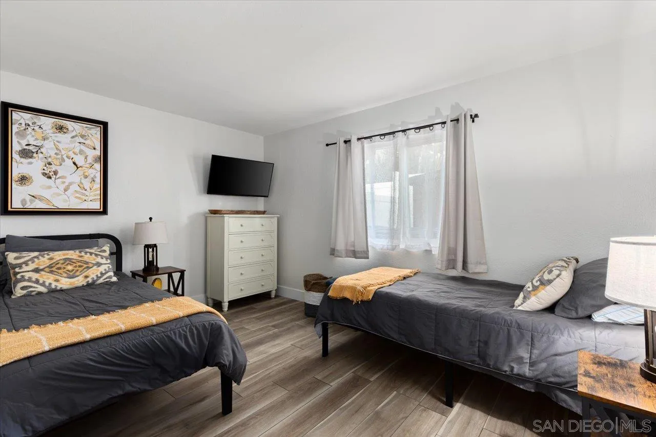 1321 Clear Crest Circle Vista, CA 92084 - Photo 13 of 30 a bedroom with a bed and wooden floor