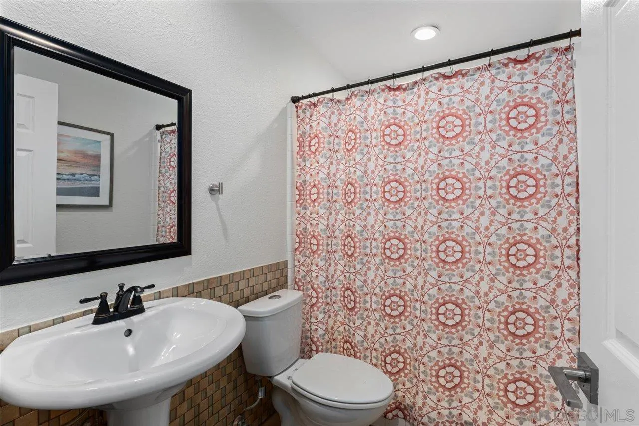 1321 Clear Crest Circle Vista, CA 92084 - Photo 14 of 30 a bathroom with a sink toilet and mirror