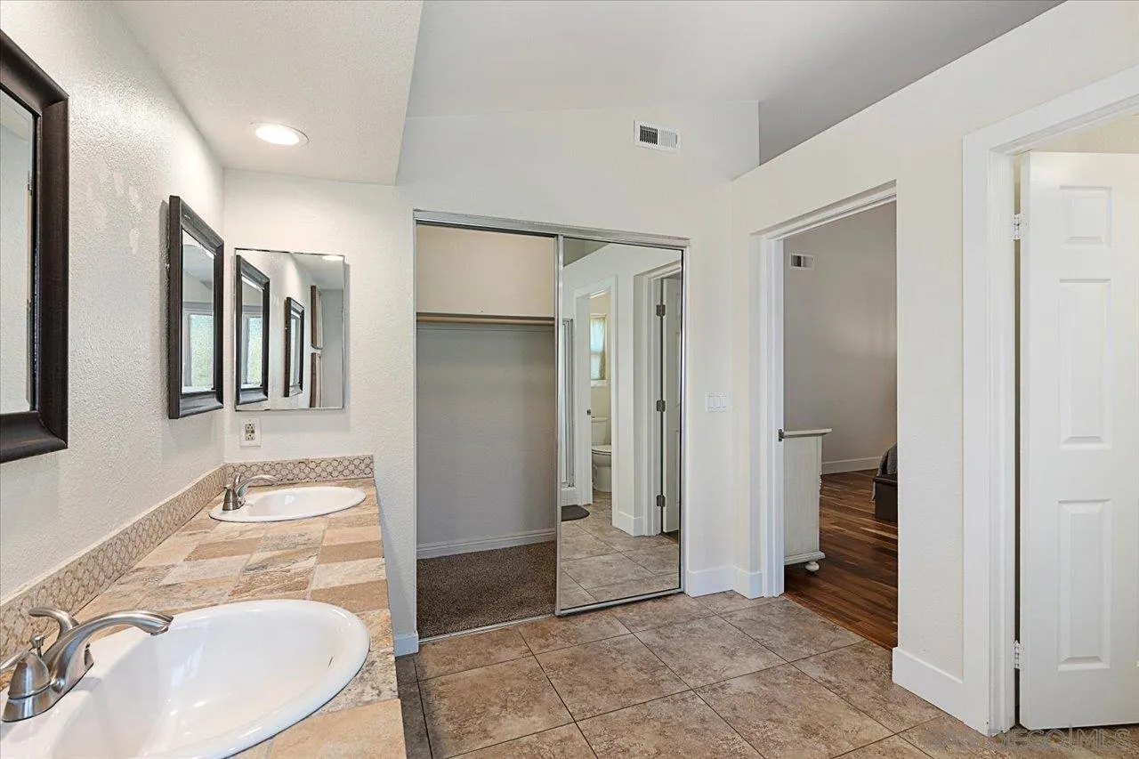 1321 Clear Crest Circle Vista, CA 92084 - Photo 18 of 30 a bathroom with a sink and a mirror