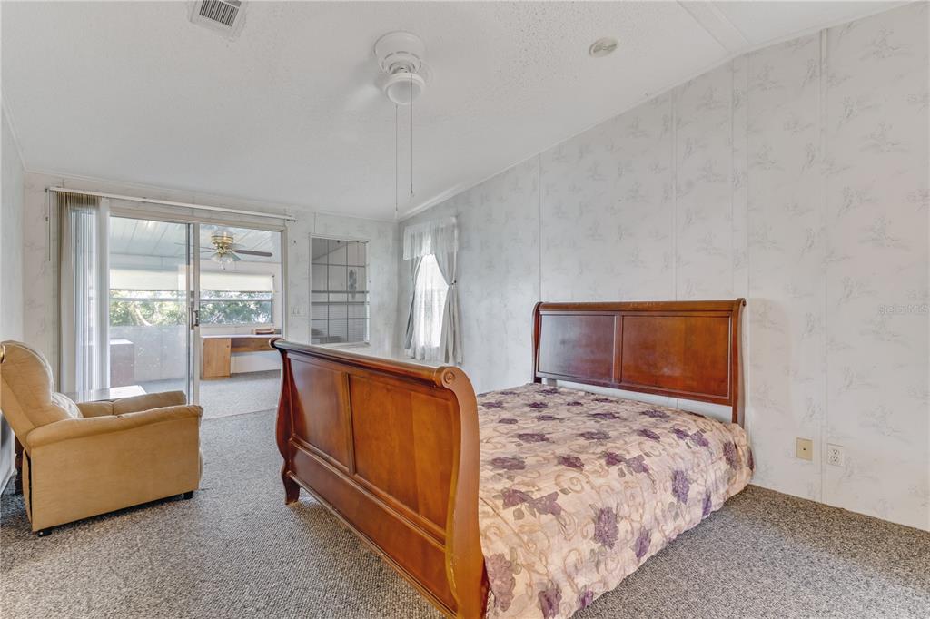 300 Beech Court Cocoa, FL 32926 - Photo 14 of 32 a bedroom with a bed and glass window