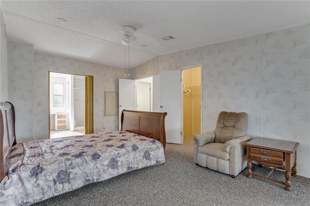 300 Beech Court Cocoa, FL 32926 - Photo 15 of 32 a bedroom with a bed and a couch