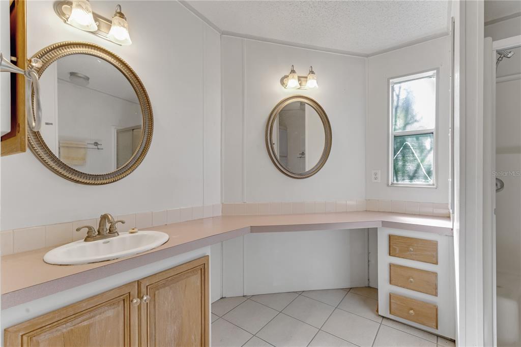 300 Beech Court Cocoa, FL 32926 - Photo 18 of 32 a bathroom with a sink and a mirror