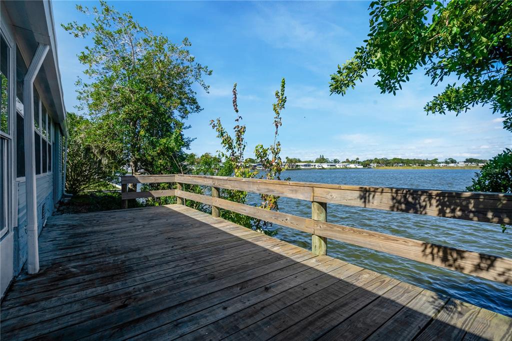 300 Beech Court Cocoa, FL 32926 - Photo 22 of 32 a view of a balcony with wooden floor and fence