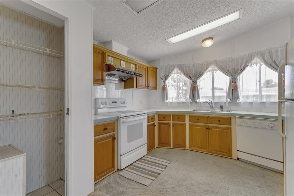 300 Beech Court Cocoa, FL 32926 - Photo 3 of 32 a large kitchen with stainless steel appliances granite countertop a stove a sink and a microwave