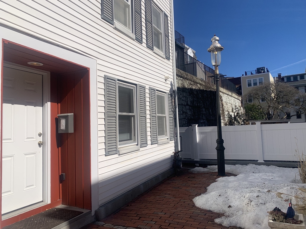 a view of a house with a door and wooden walls