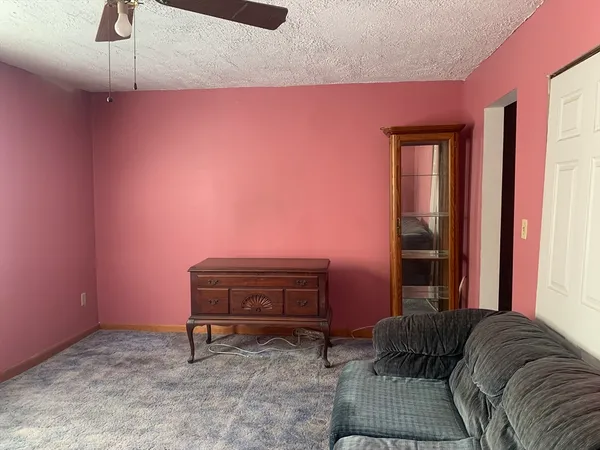 a living room with furniture and a piano