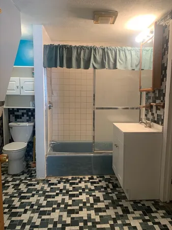 a bathroom with a bathtub and a sink