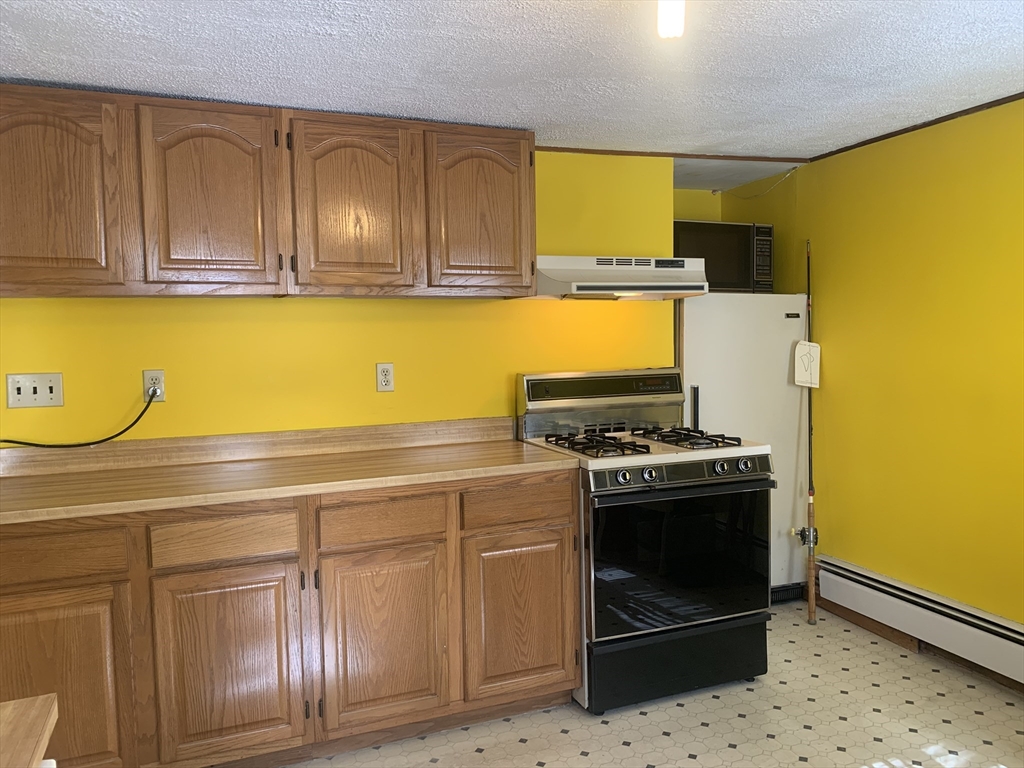 8 Avon Place Boston, MA 02129 - Photo 6 of 23 a kitchen with granite countertop cabinets and black stainless steel appliances