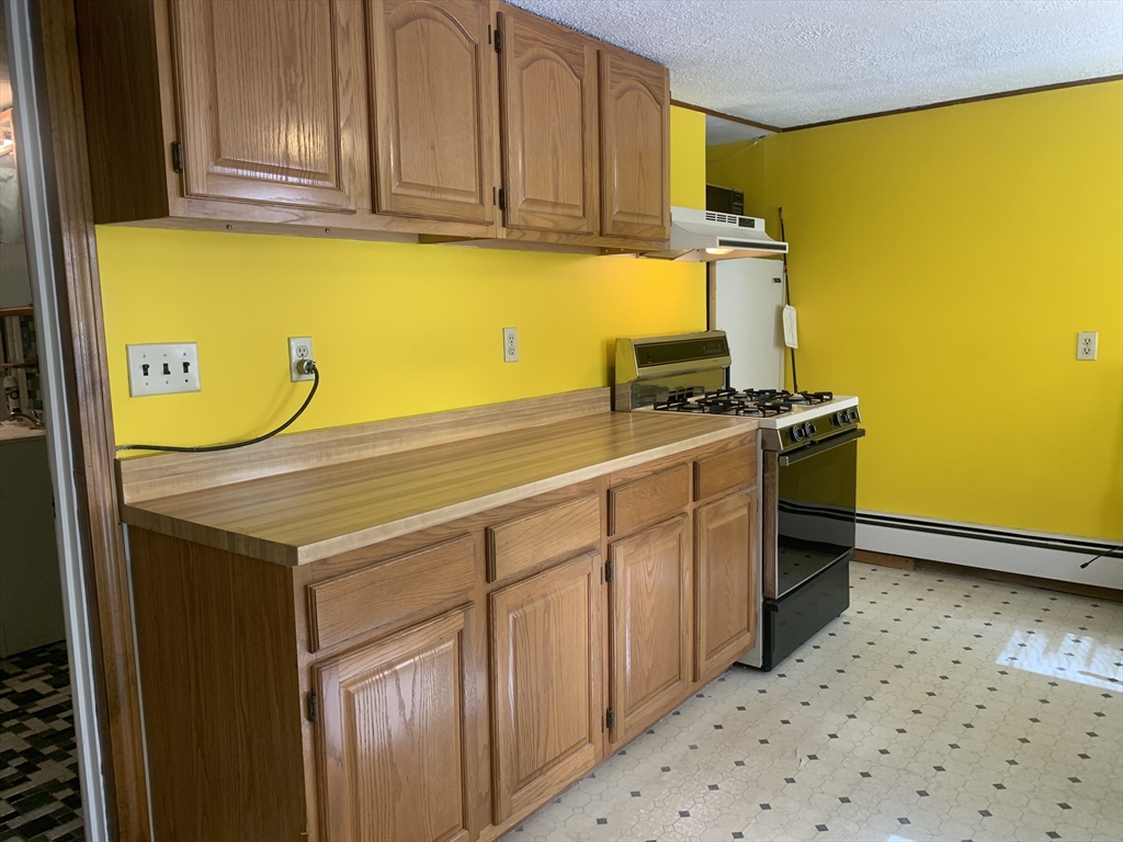 8 Avon Place Boston, MA 02129 - Photo 7 of 23 a kitchen with a sink stove and cabinets