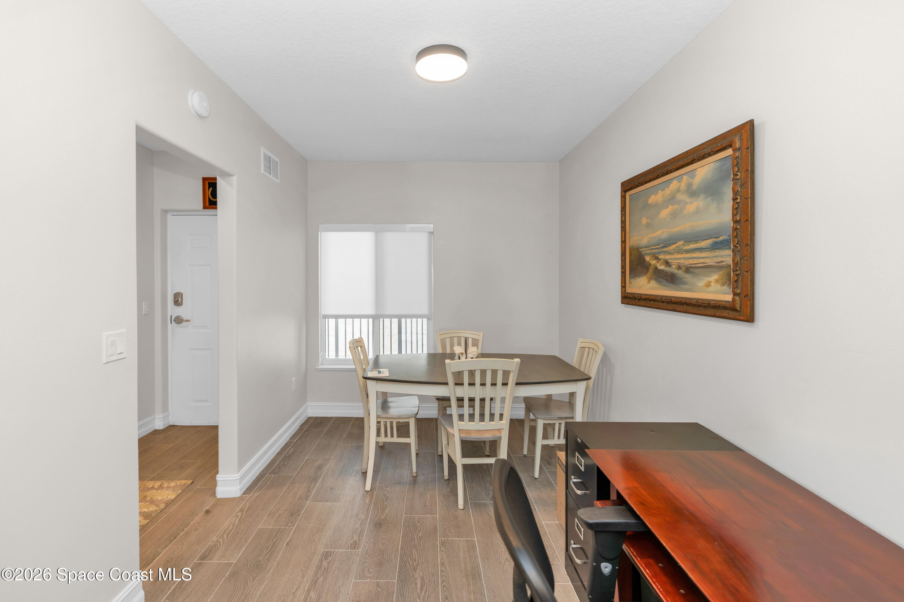 1805 Riverside Drive, Unit 506 Titusville, FL 32780 - Photo 11 of 24 a workspace with furniture and wooden floor